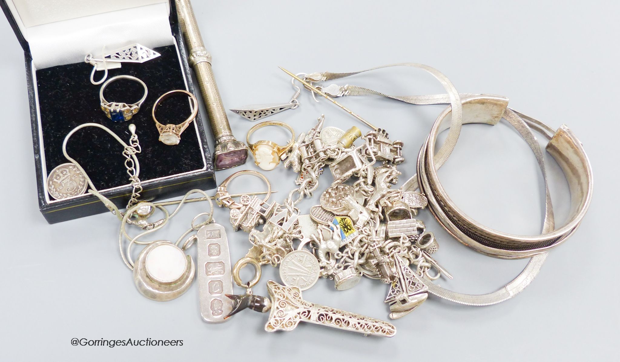 A group of assorted silver jewellery including a charm bracelet and a telescopic pencil